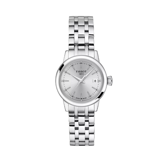 Tissot Classic Dream er en dameklokke på 28 mm. Klokken i stål har en grå tallskive med dato kl 3. Lenken i stål har butterfly clasp. 50 meter vanntett.